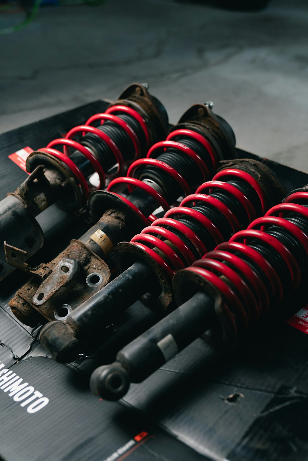 O Nas four-red-coilover-suspension-assemblies-on-a-black-surface-0lrw9vqbtgo